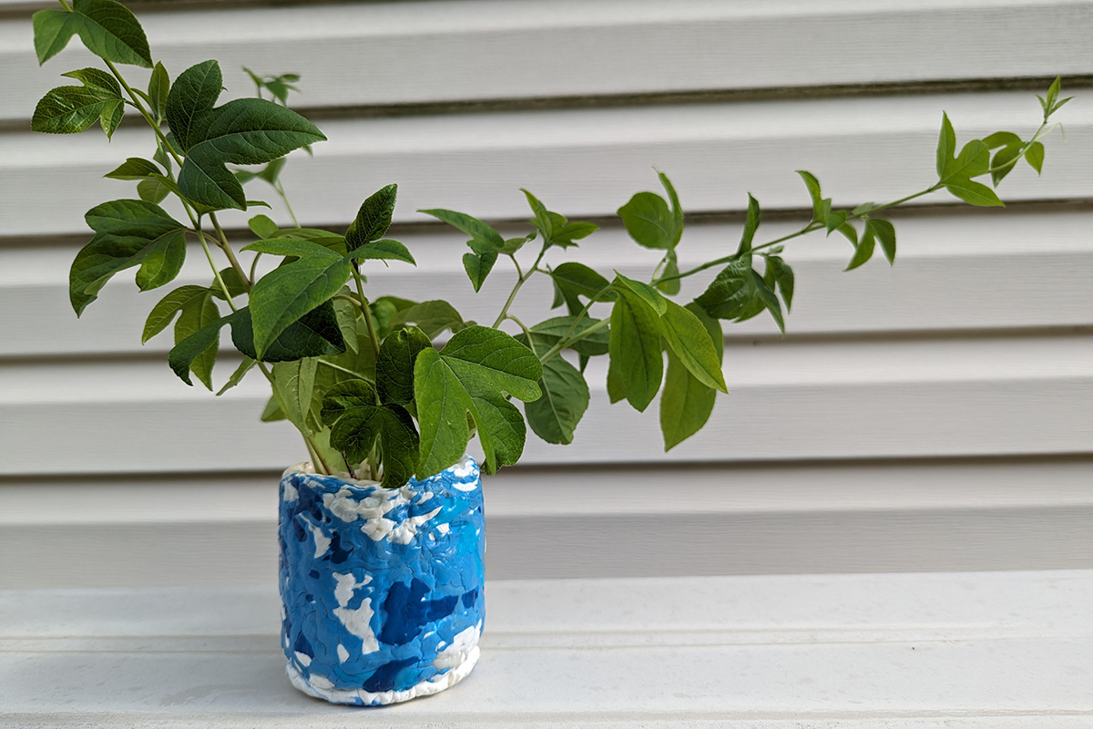 A small HDPE planter made from 100% recycled post-consumer products. Blue from detergent bottles and white from milk jugs.
